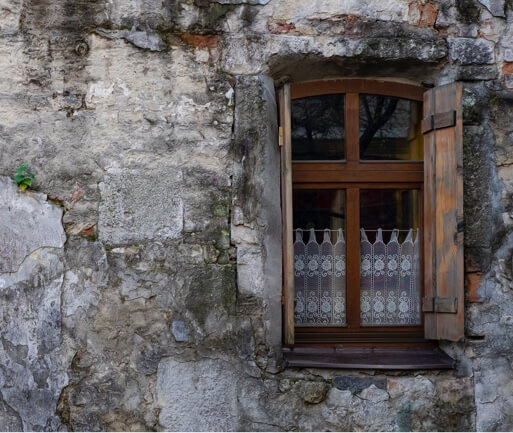 a rustic building with a wooden window